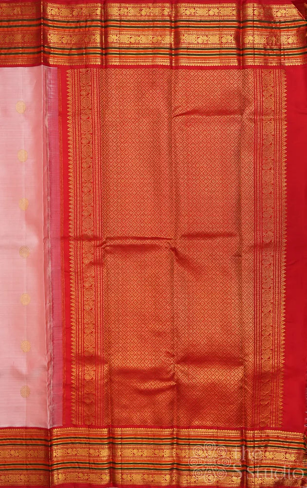 Light peach kanchi silk saree with ganda berunda motifs and korvai red borde
