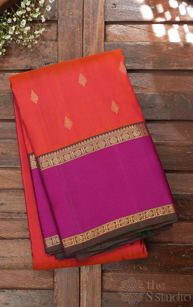 Bright orange kanchipuram silk saree with manthulir green border