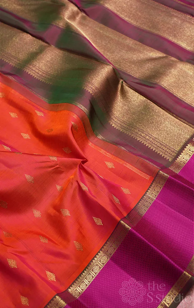 Bright orange kanchipuram silk saree with manthulir green border