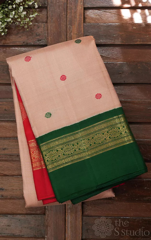 Light peach korvai kanjivaram silk saree with red and green korvai border