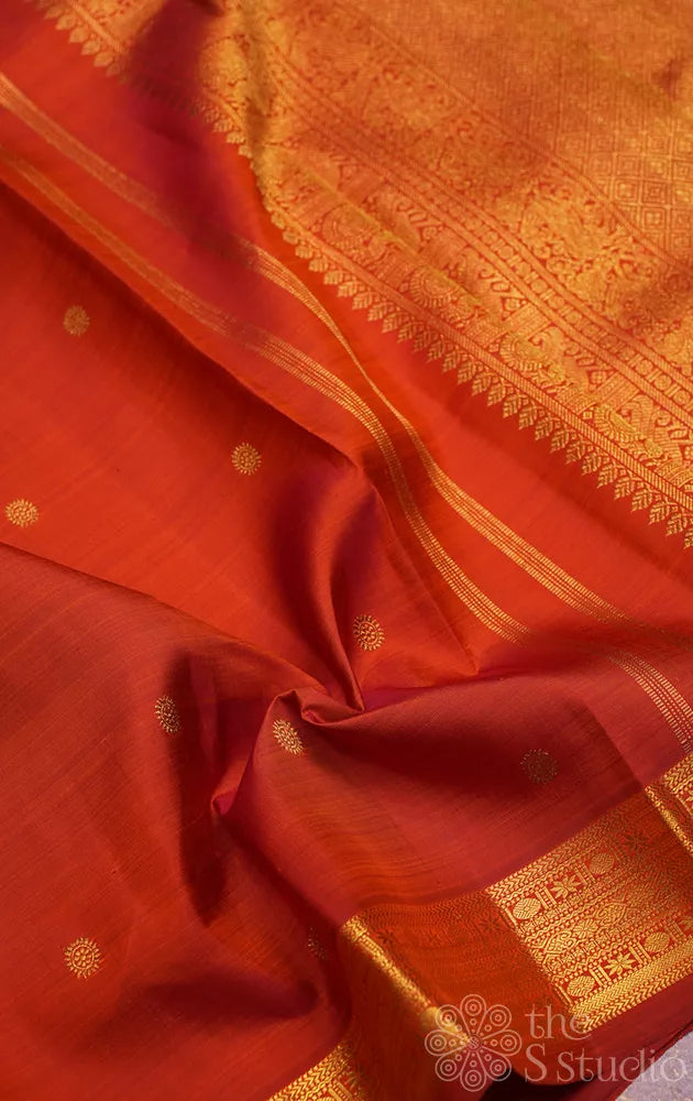 Rust kanchi silk saree with kamalam buttas and zari woven border
