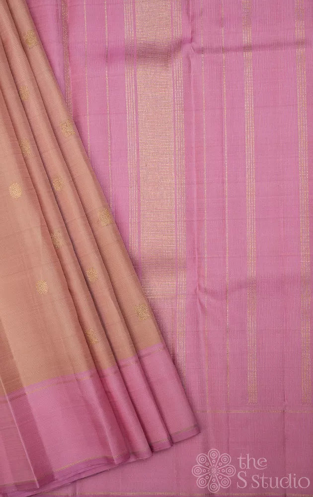 Light peach kanchi silk saree with zari bhuttas and pink border
