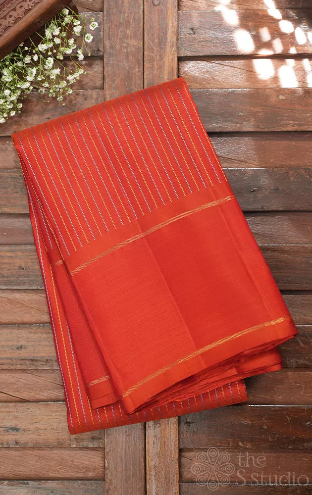 Rust kanjivaram silk saree with thread lines and simple zari border