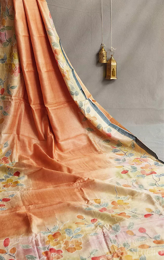 Shades of peach and light yellow tussar silk saree with batik print