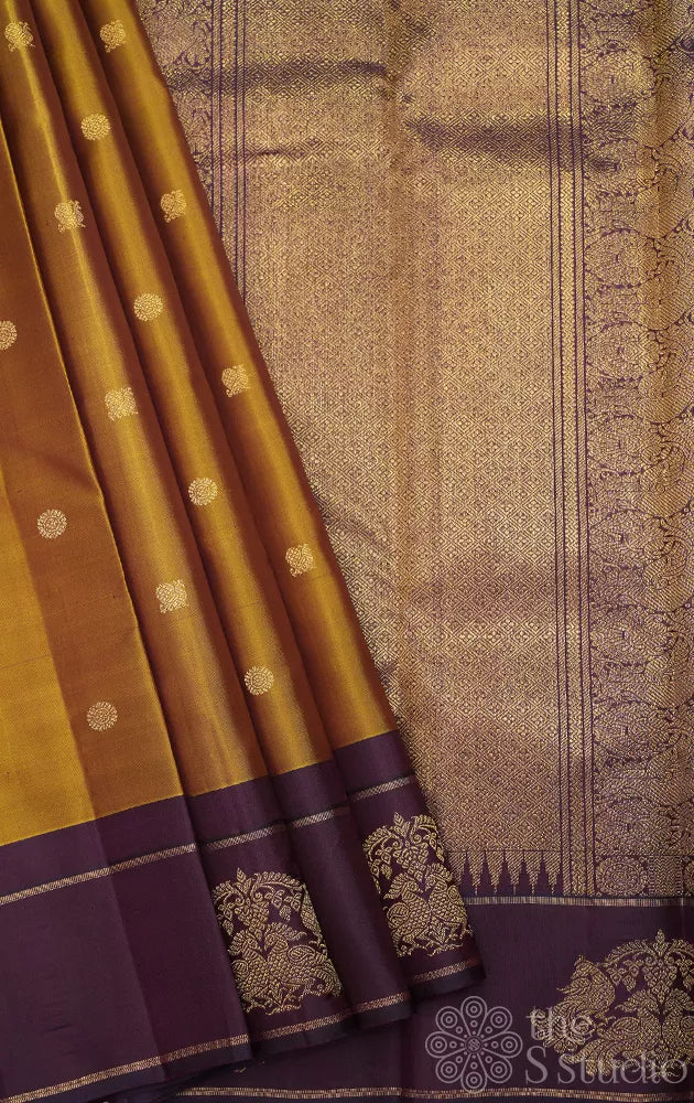 Golden green kanchi pattu saree with deep purple border