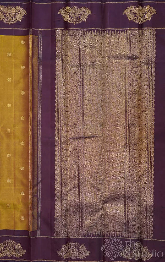 Golden green kanchi pattu saree with deep purple border
