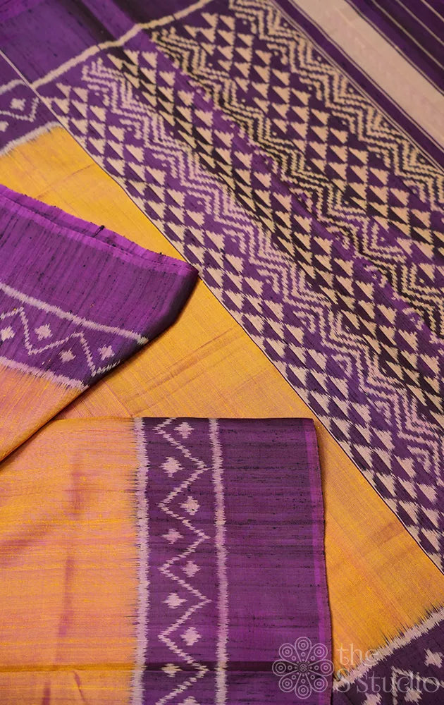 Light peach patola raw silk saree with purple border