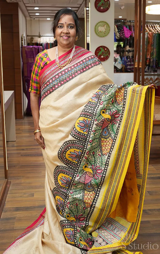 Beige vidharbha tussar silk saree with rani pink and yellow ganga jamuna border and madhubani hand painting