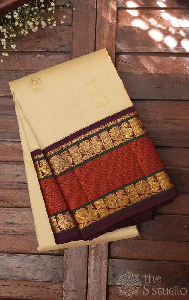 Cream kanjivaram silk saree with brown korvai rettaipet border
