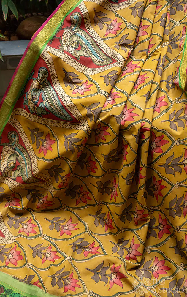 Mustard pen kalamkari hand painted kanchipuram silk saree with green pallu and small border