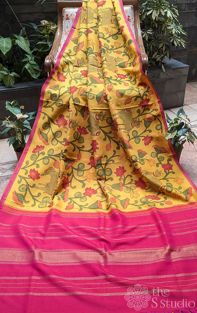 Yellow kanchipuram silk saree with kalamkari hand painting and a contrast rani pink pallu