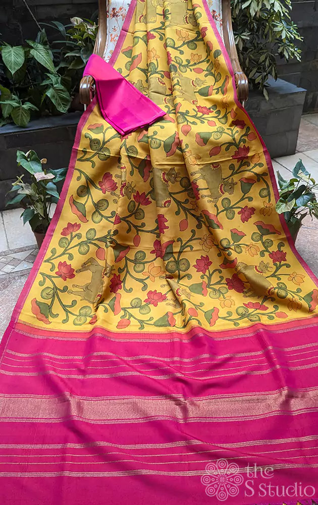 Yellow kanchipuram silk saree with kalamkari hand painting and a contrast rani pink pallu