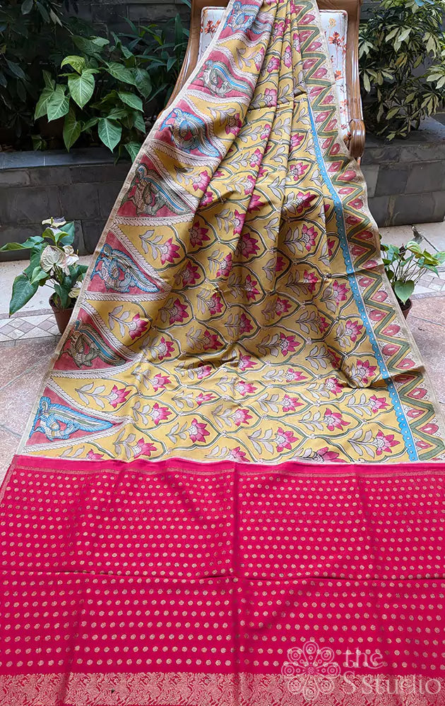 Yellow hand painted kanchi kalamkari saree with a contrast maroon pallu and butta blouse