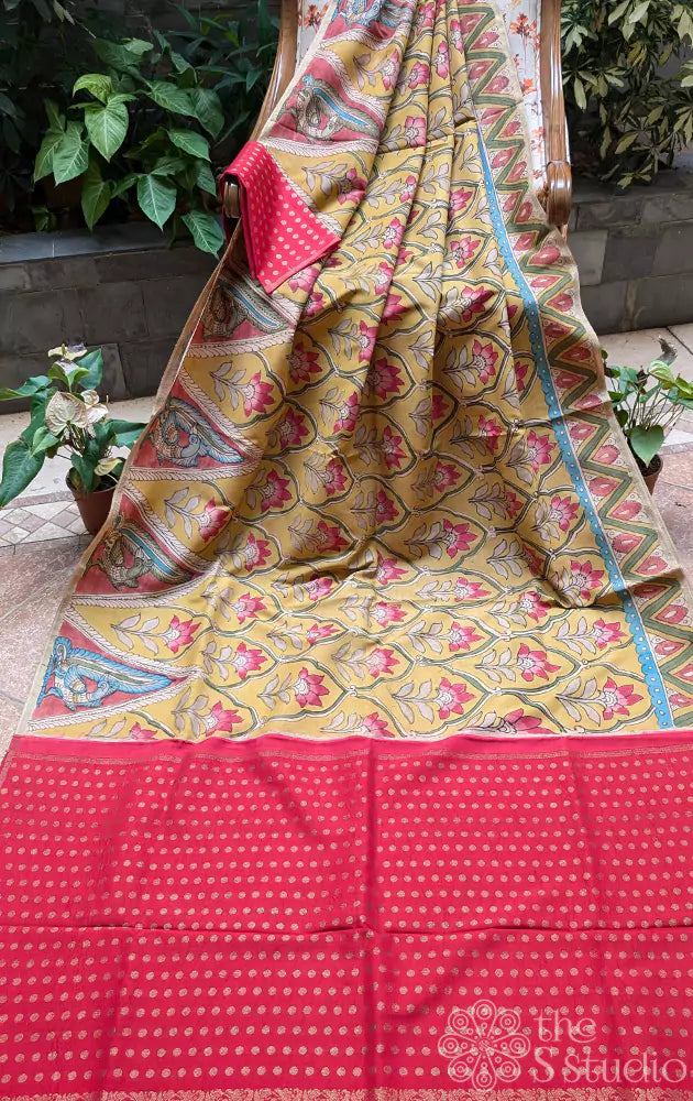 Yellow hand painted kanchi kalamkari saree with a contrast maroon pallu and butta blouse