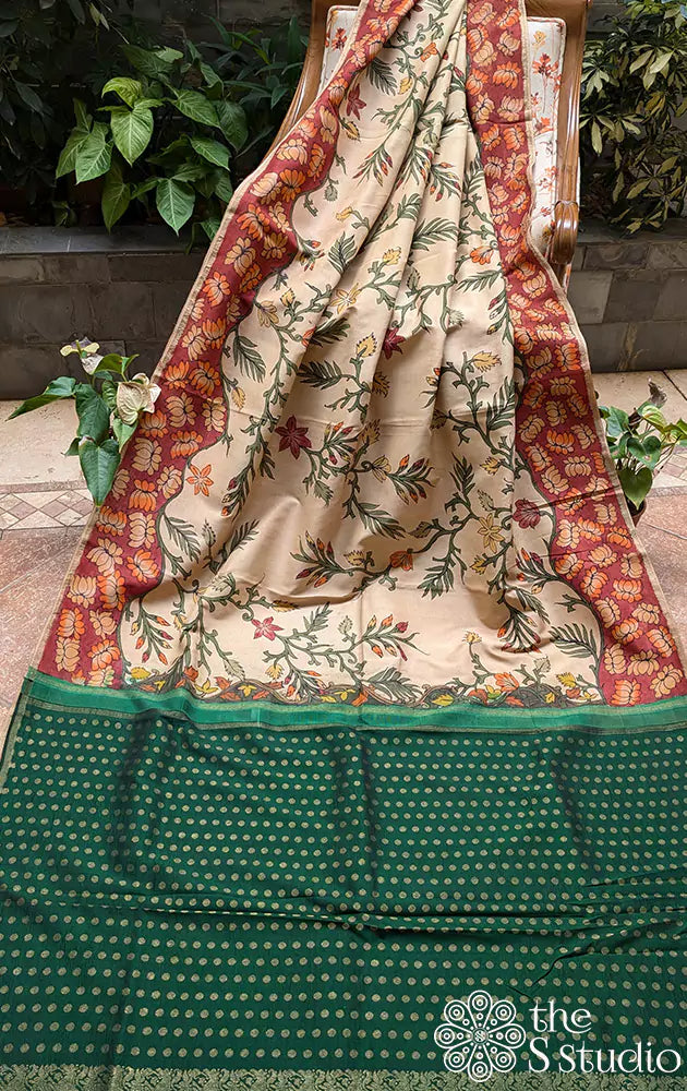 Off white hand painted kalamkari on a kanchipuram silk saree with contrast green pallu and butta blouse