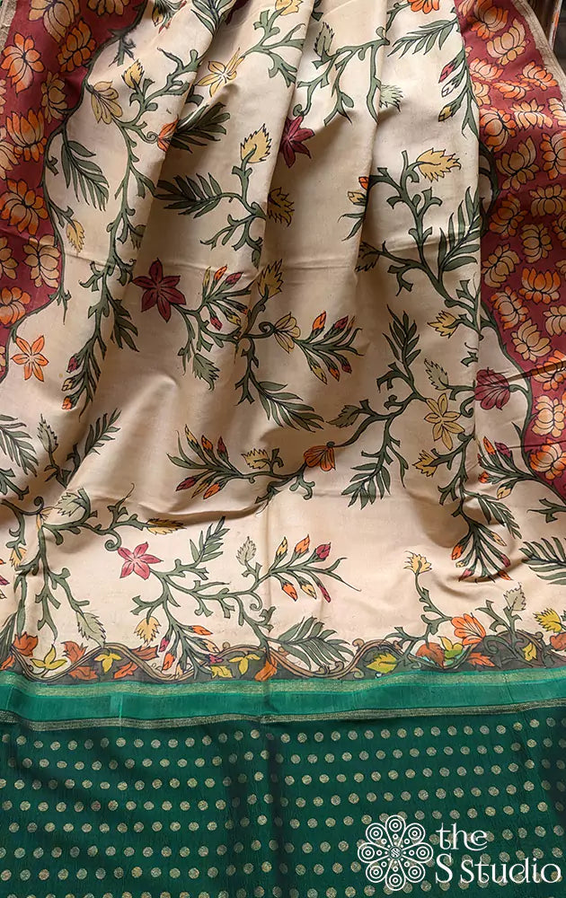 Off white hand painted kalamkari on a kanchipuram silk saree with contrast green pallu and butta blouse