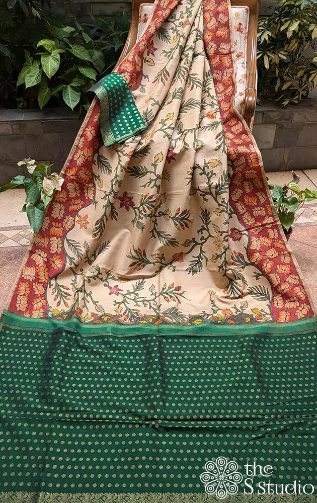 Off white hand painted kalamkari on a kanchipuram silk saree with contrast green pallu and butta blouse