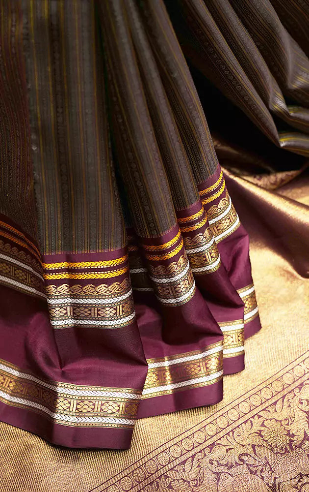 Deep brown kanjivaram saree with thread woven body and a zari rich border