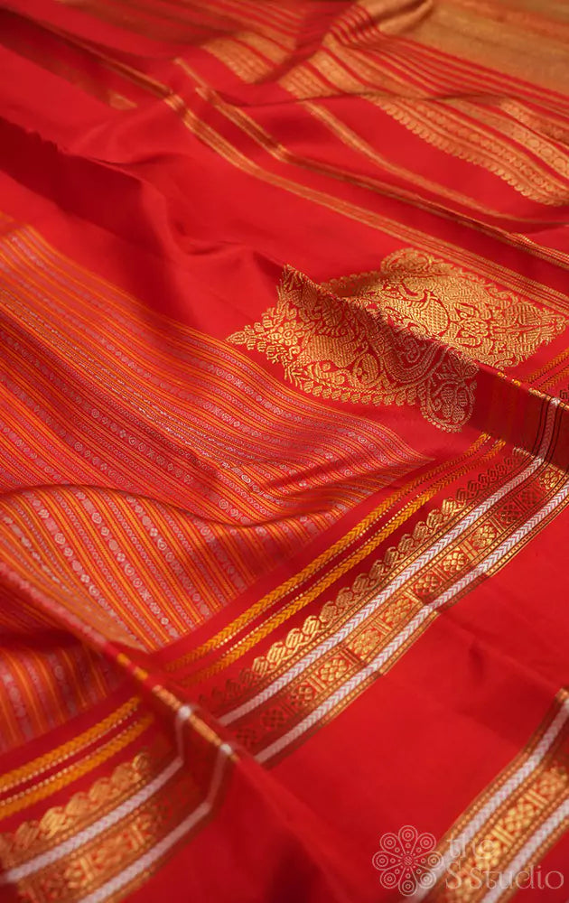 Red kanjivaram saree with thread woven body and a zari rich border