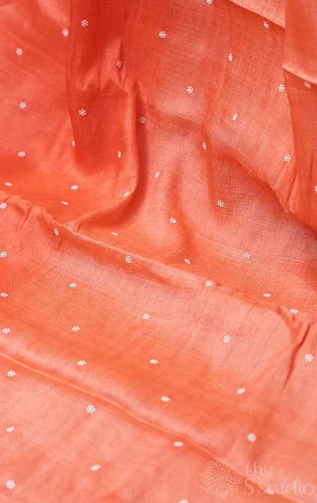Peach shaded tussar silk saree with white floral embroidery and scallop border