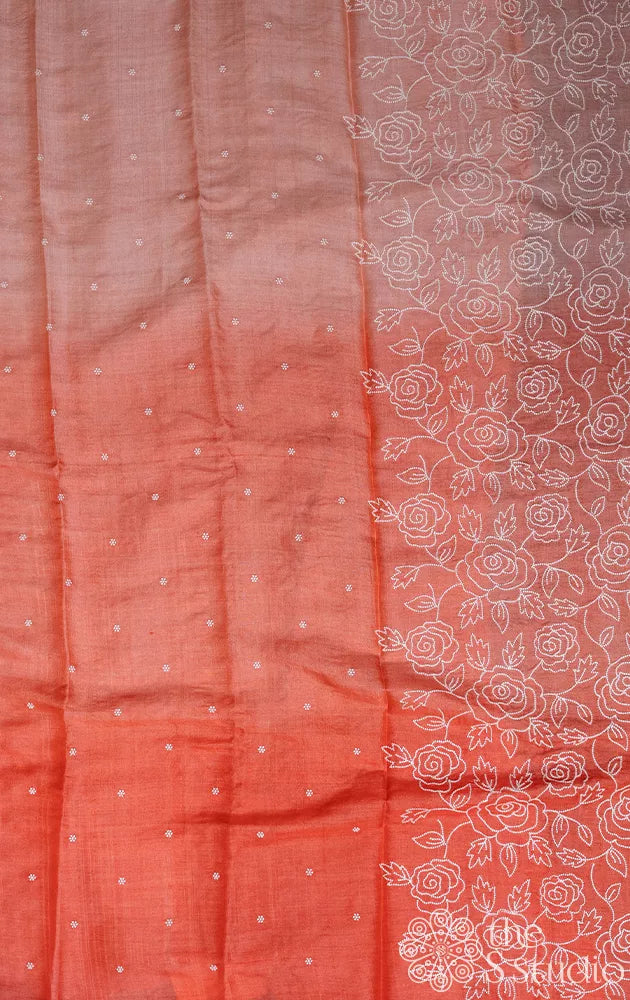Peach shaded tussar silk saree with white floral embroidery and scallop border