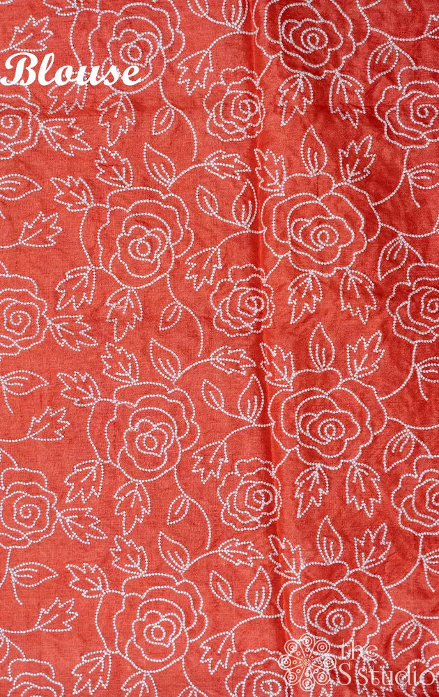 Peach shaded tussar silk saree with white floral embroidery and scallop border