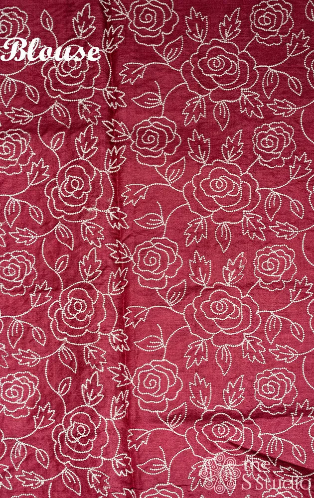 Maroon shaded tussar silk saree with white floral embroidery and scallop border
