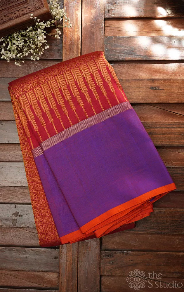 Reddish orange kanchi silk saree with a purple border