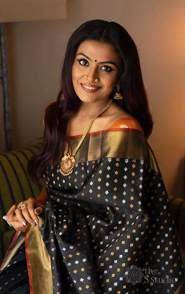Black Kanchipuram silk saree with silver and gold zari buttas