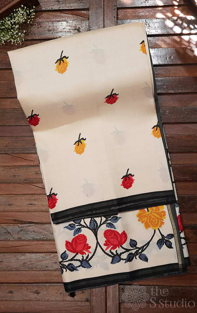 White kanchi pattu saree with floral prints and black pallu