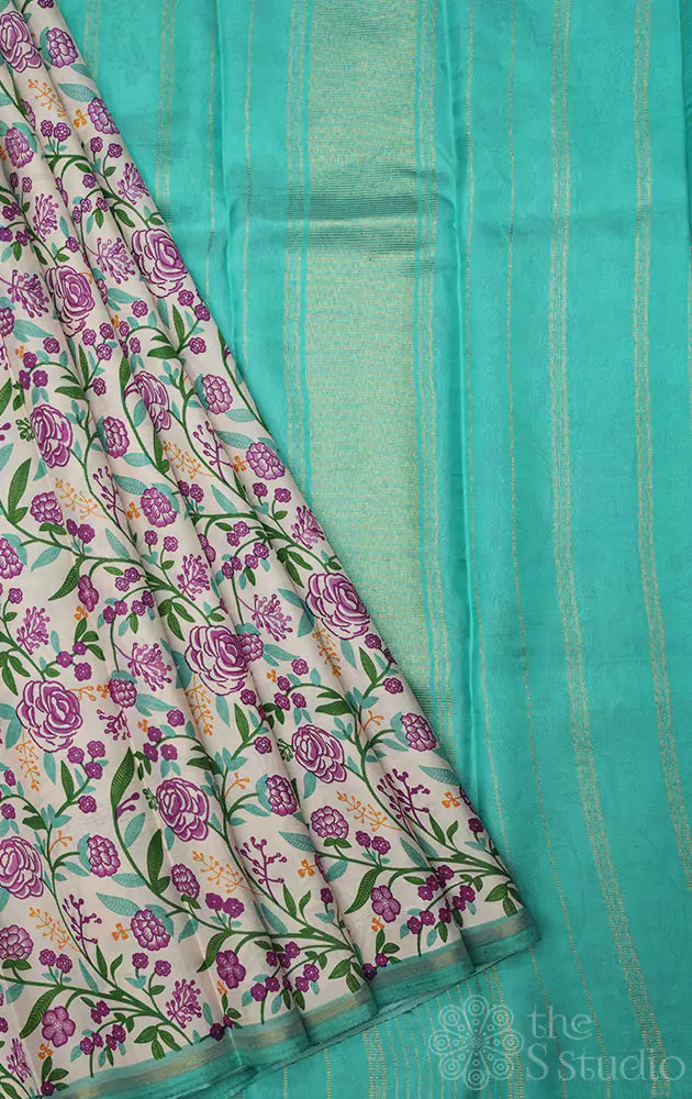 Off white kanchipuram silk saree with small floral prints and sea green pallu