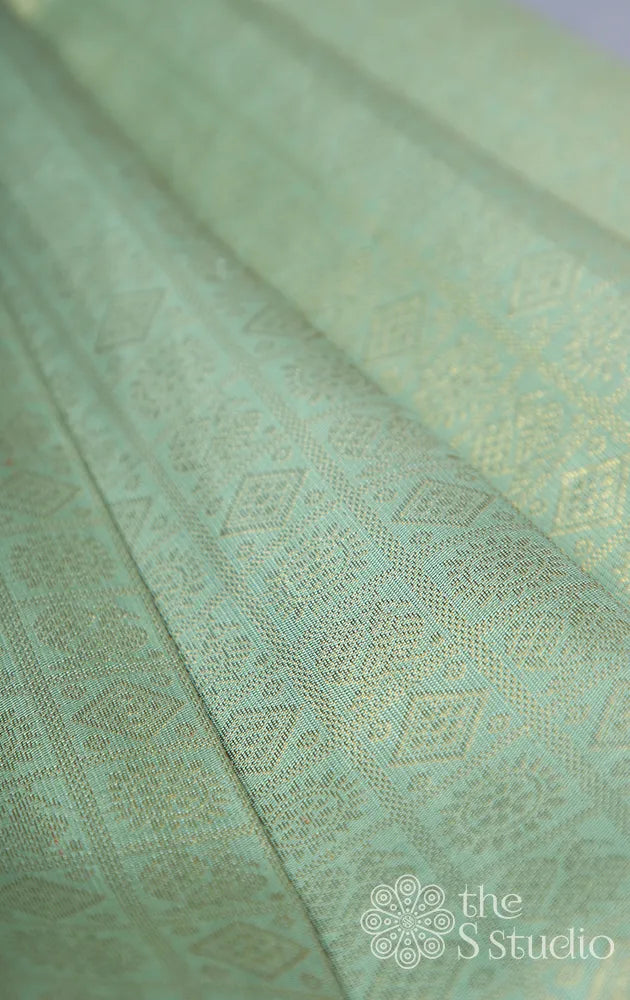 Elachi green kanchi silk blouse material with mayil chakaram buttas