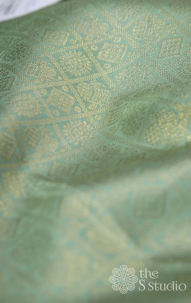 Elachi green kanchi silk blouse material with mayil chakaram buttas