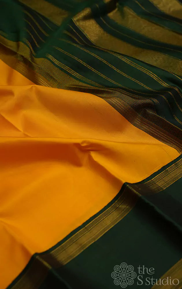 Yellow kanchi silk saree with rettapet korvai green border