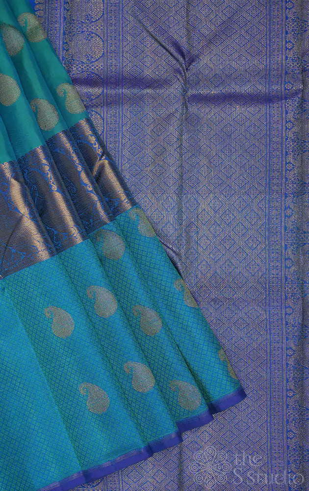 Sea green kanchi silk saree with paisley motifs and a long border