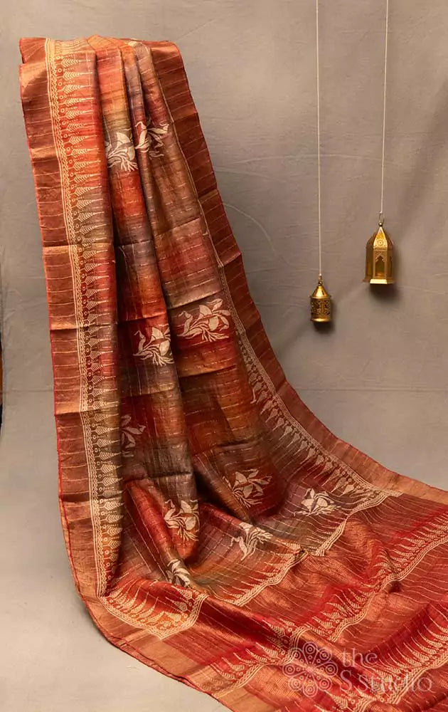 Rust zari checked tussar saree with floral prints