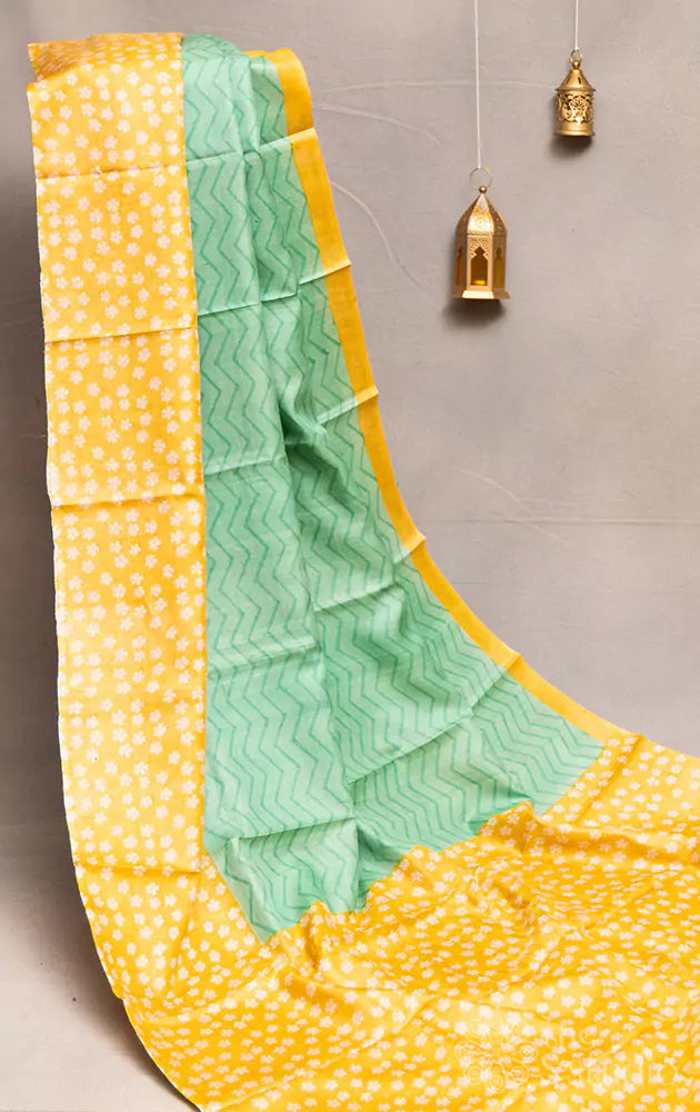 Sea green tussar silk saree with yellow floral printed border