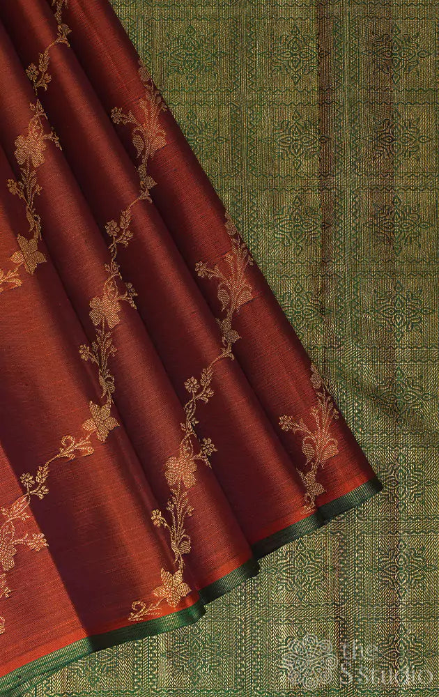 Rust with zari floral veins kanjivaram saree with contrast green pallu