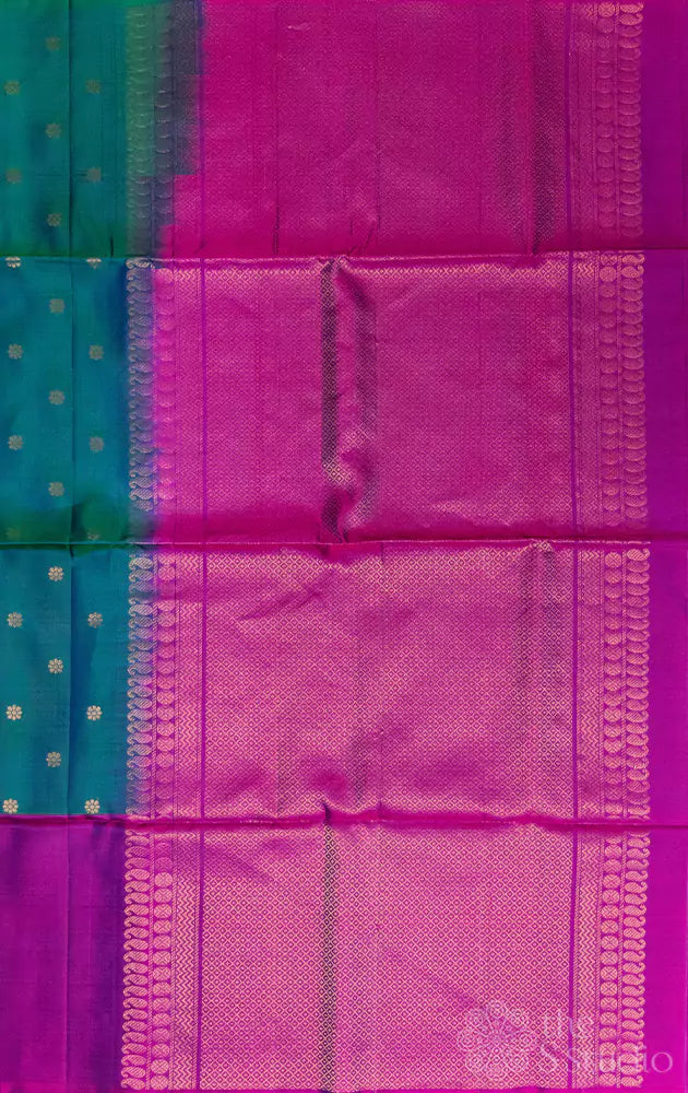 Bluish green soft silk saree with purple border and paisley motifs