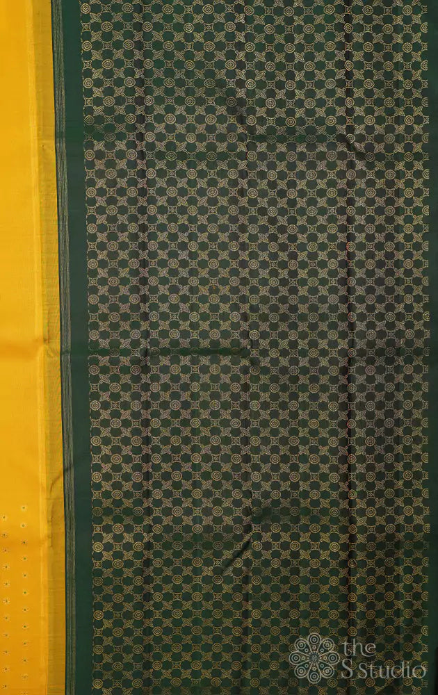Yellow kanchipuram silk saree woven with meena buttas and a contrast green pallu