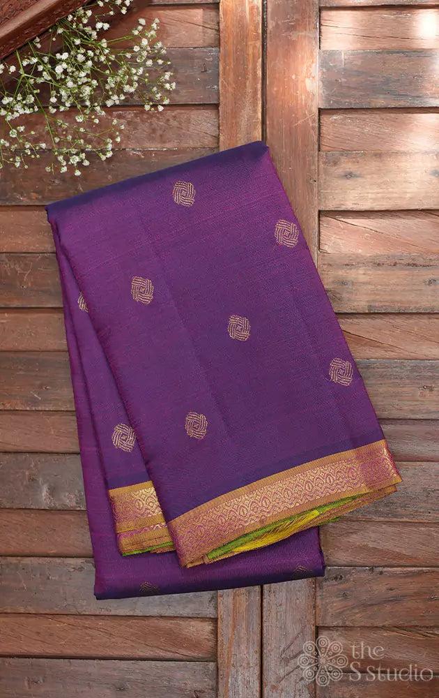 Purple kanjivaram silk saree with small dual tone border and green pallu