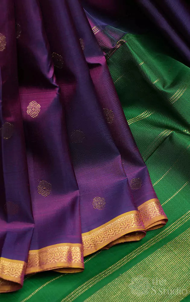 Purple kanjivaram silk saree with small dual tone border and green pallu