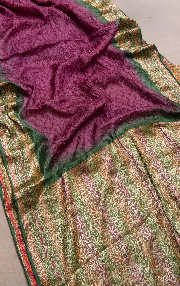 Purple bandhani saree with green border and a brocade pallu