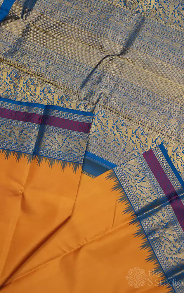 Mustard kanchi silk saree with korvai anandha blue border