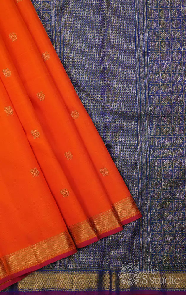 Orange kanchi silk saree with peacock blue pallu
